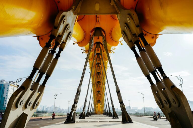 Dramatic view of the Dragon Bridge's engineering with a cityscape in the background.