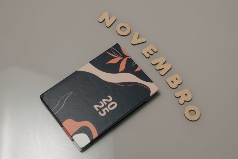 Stylish 2025 planner with abstract design and 'November' spelled out in wooden letters.