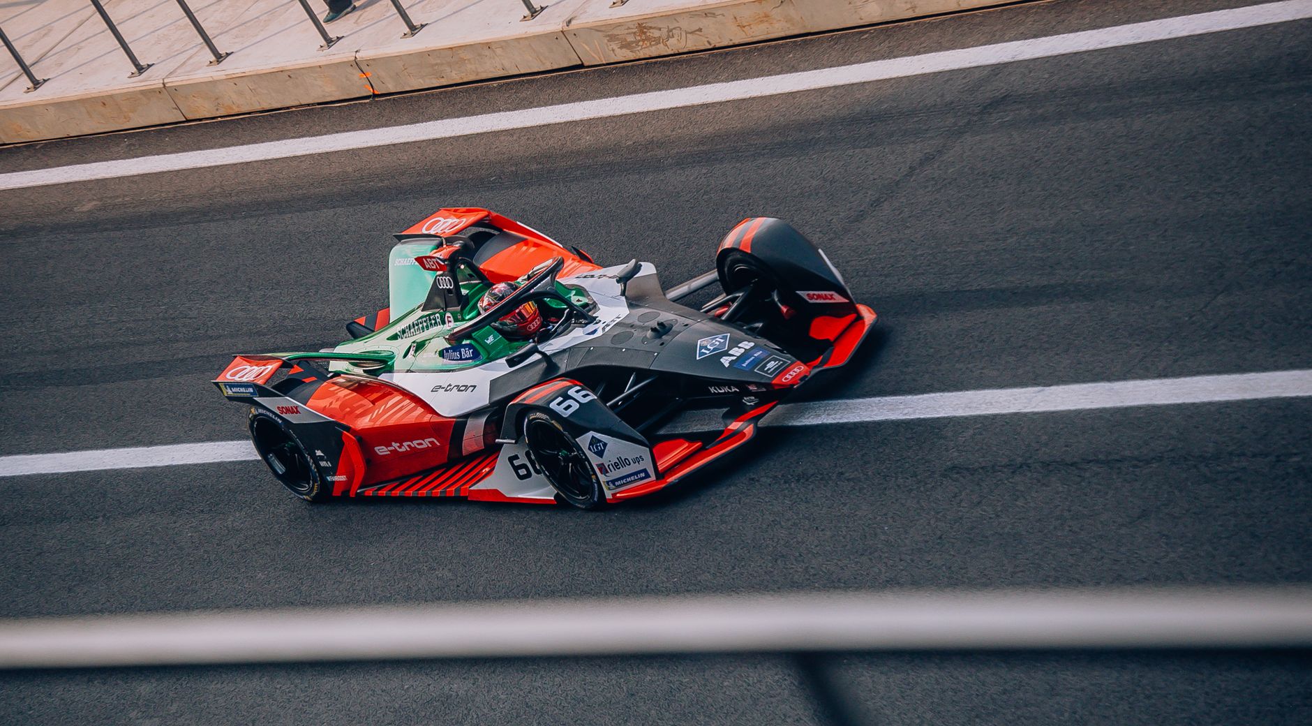 Dynamic view of a Formula E car racing on the track in Mexico City.