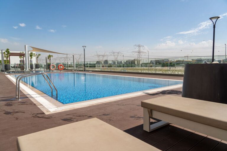 Inviting rooftop pool with Dubai skyline backdrop, perfect for relaxation and luxury living.