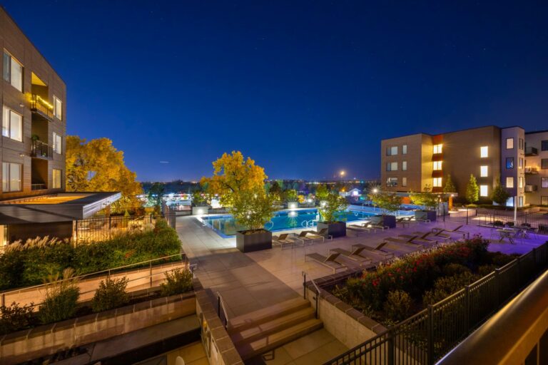 Night view of a luxurious apartment complex with a swimming pool in Westminster, Colorado, USA.