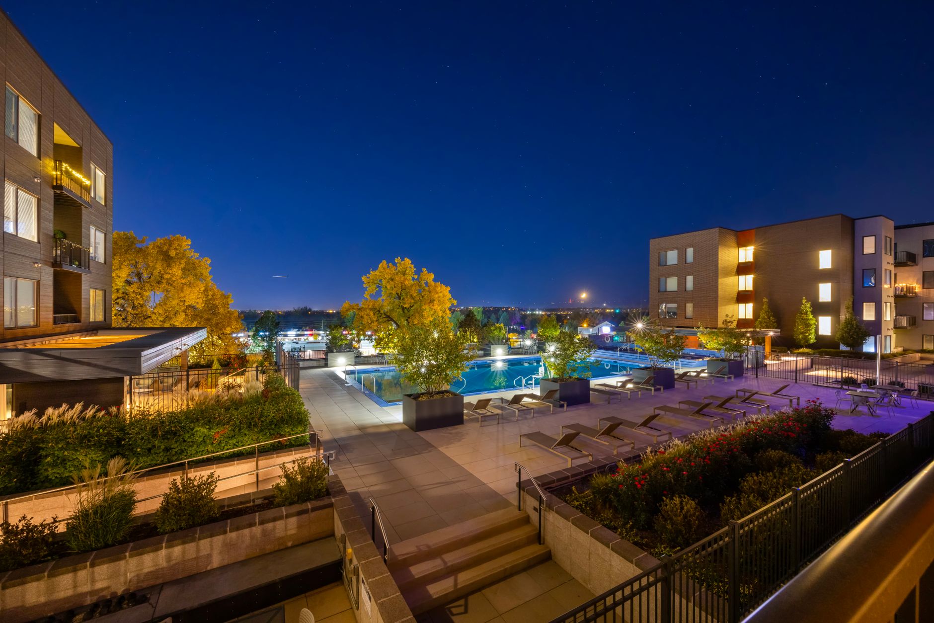 Night view of a luxurious apartment complex with a swimming pool in Westminster, Colorado, USA.