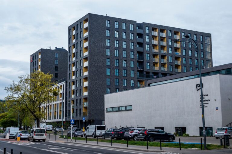 Contemporary architecture of residential buildings in an urban setting, featuring modern design and street elements.