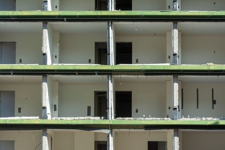 Close-up view of a partially demolished urban building showing exposed concrete and empty rooms.