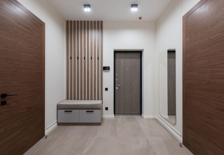 Interior of modern empty spacious hallway with white walls and big mirror in apartment