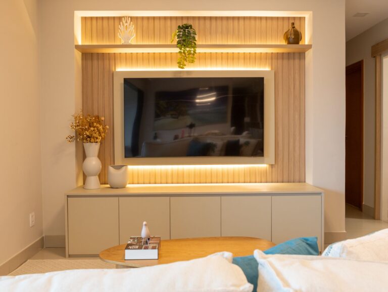 Elegant living room featuring a modern entertainment setup and stylish decor in neutral tones.