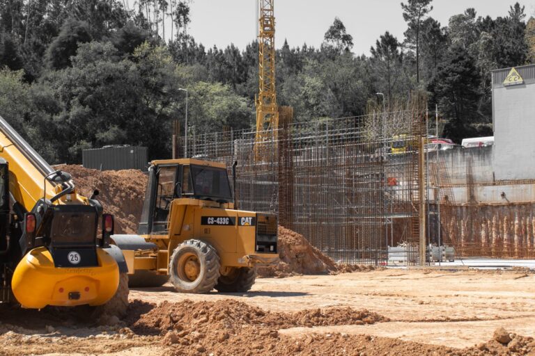 Construction site featuring heavy machinery and crane, showcasing industrial development.