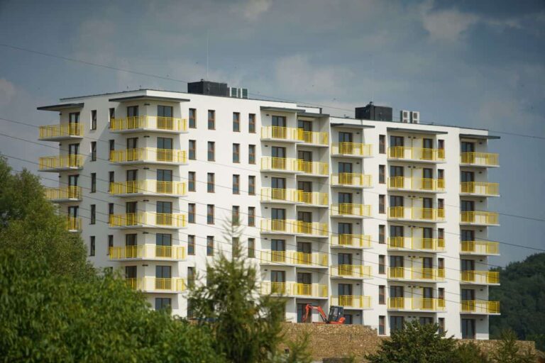 Photography of a modern apartment building with yellow balconies in Trzebinia, Poland